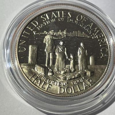 1986-S PROOF STATUE OF LIBERTY HALF DOLLAR IN A MINT HOLDER AS PICTURED.