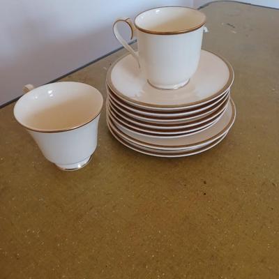 10 gold rimmed glasses and plates