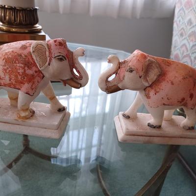 2 stone/marble elephants trunk up