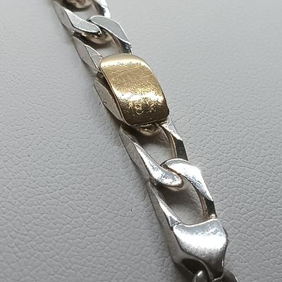 LOT 105: Tiffany and Co. Sterling Silver and 18K Gold Curb Link Bracelet
