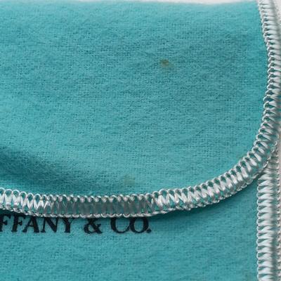 LOT 105: Tiffany and Co. Sterling Silver and 18K Gold Curb Link Bracelet