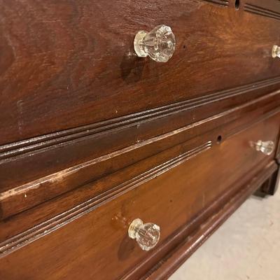 ANTIQUE 4 DRAWER CHEST WITH GLASS KNOBS ON WOODEN WHEELS