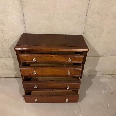 ANTIQUE 4 DRAWER CHEST WITH GLASS KNOBS ON WOODEN WHEELS