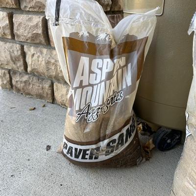 RUBBERMAID TRASH CAN AND 3 BAGS OF PAVER SAND