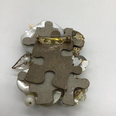Vintage design with puzzle pieces pin