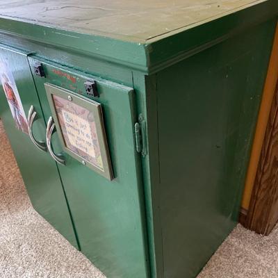 Small green cabinet with drawer