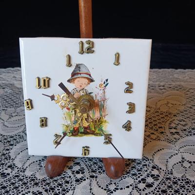 SMALL BATTERY OPERATED CLOCK ON STAND AND A GERMAN SHOT GLASS