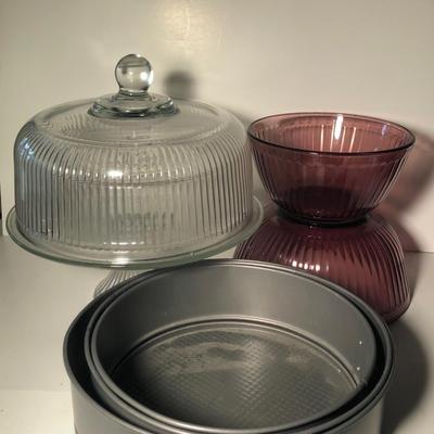 LOT 327L: Glass Cake Stand w/ Cloche, Spring Form Cake Pans & Pink Glass Pyrex Mixing Bowls