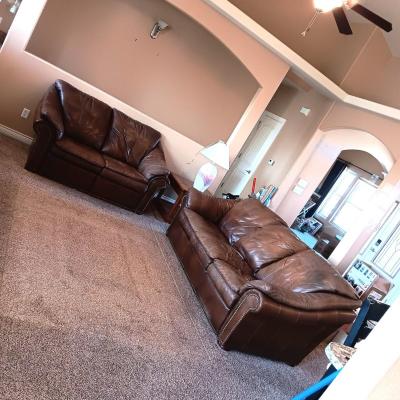 LEATHER RECLINING SOFA AND LOVESEAT WITH NAILHEAD ACCENTS