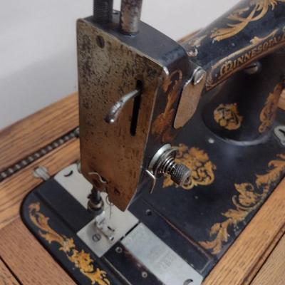 Antique Cast Body Minnesota Treadle Sewing Machine in Oak Cabinet