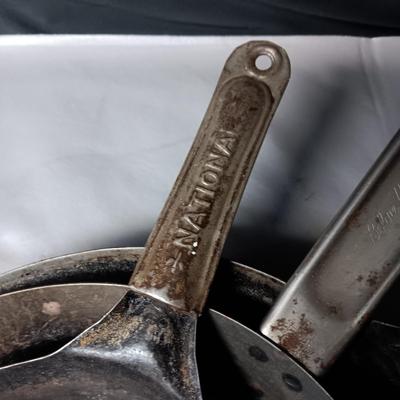 4 ANTIQUE SKILLETS, NATIONAL-COLD HANDLE AND 1 UNKNOWN