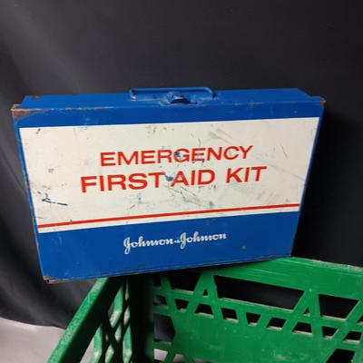 HEAVY PLASTIC MILK CRATE AND A METAL FIRST-AID KIT WITH SOME CONTENTS