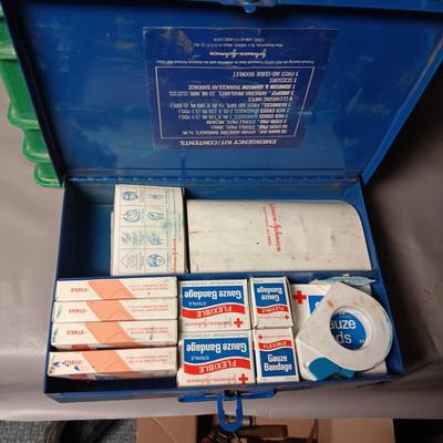 HEAVY PLASTIC MILK CRATE AND A METAL FIRST-AID KIT WITH SOME CONTENTS
