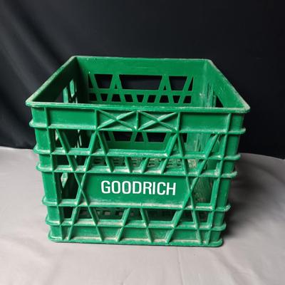 HEAVY PLASTIC MILK CRATE AND A METAL FIRST-AID KIT WITH SOME CONTENTS