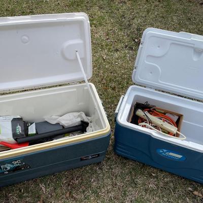 2 large blue coolers with hardware in them