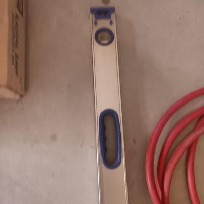 AN ALUMINUM LEVEL, EXTENSION CORD AND AIR HOSE