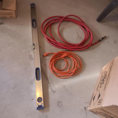AN ALUMINUM LEVEL, EXTENSION CORD AND AIR HOSE