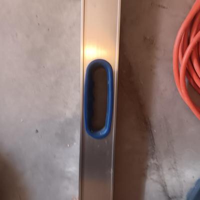 AN ALUMINUM LEVEL, EXTENSION CORD AND AIR HOSE