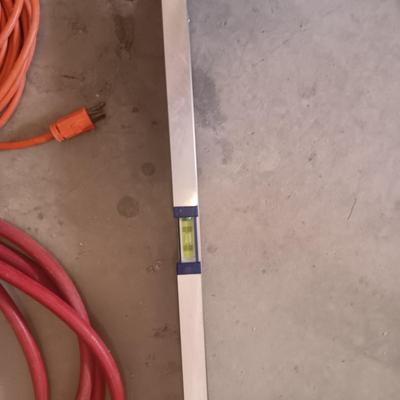 AN ALUMINUM LEVEL, EXTENSION CORD AND AIR HOSE