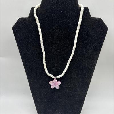 White necklace with pink flower