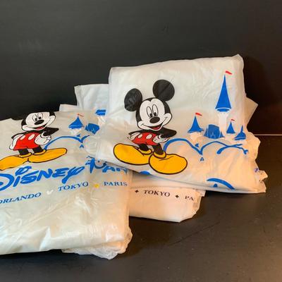LOT:62: Large Assortment of Disney Items Featuring Alice in Wonderland Teacups, Woman's Mickey Sweatshirt, Travel Mugs, Ponchos, and Much...