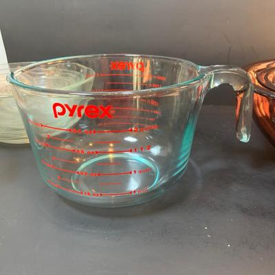 LOT:72: Vintage Large Pyrex Measuring Cups, Pyrex Amethyst Nesting Mixing Bowls, Duralex Clear Nesting Bowls and a Contempory Hummingbird...