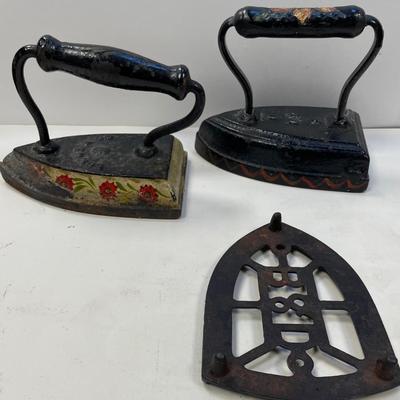 Two Antique Cast Iron Sad Flat Iron w/ B and D Footed Trivet