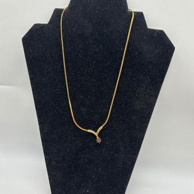 Gold toned charm necklace