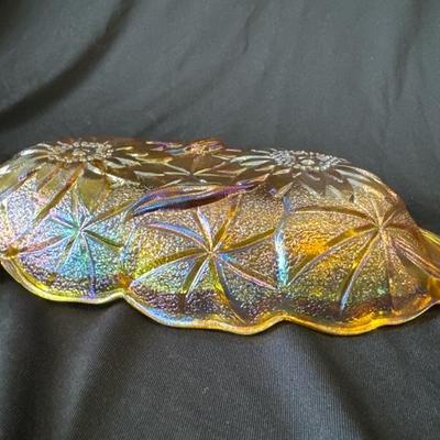 Sale Photo Thumbnail #765: Vintage Carnival Glass Oval Shaped Amber Serving Dish with Sunflowers on UnderSide

Handles on each end, Dish reflects an array of colors dependent on the light, you may see greens, mauves, blues, amazing! 

This dish is in excellent condition with no cra