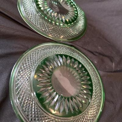 Sale Photo Thumbnail #802: This auction is for two plates in green cut glass likely Bohemian crystal, one has a small glass air bubble near the base, look to be mid century 20th century vintage. No marks or quality issues in the glass itself.