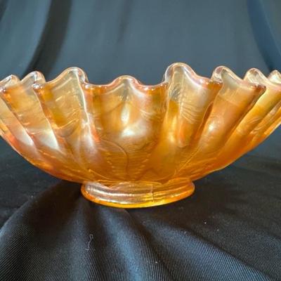 Sale Photo Thumbnail #805: This listing is for a vintage Fenton marigold carnival glass bowl that has the Thistle pattern on it. The bowl measures around 8 and 1/4 inches wide and stands around 2 and 1/2 inches tall. The bowl is in excellent condition with no cracks or chips. 

We 