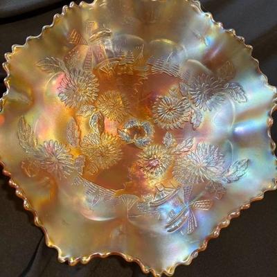 Sale Photo Thumbnail #823: Spring is in this bowl!

Fenton 3 Footed Bowl Marigold Carnival Glass Chrysanthemum & Windmill. 9 1/2" across x 4 1/2" high.

No chips, cracks or damage.

See pictures for details.