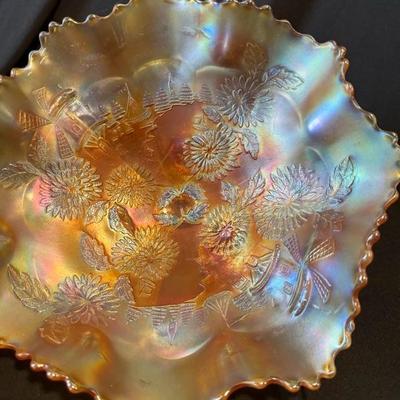 Sale Photo Thumbnail #822: Spring is in this bowl!

Fenton 3 Footed Bowl Marigold Carnival Glass Chrysanthemum & Windmill. 9 1/2" across x 4 1/2" high.

No chips, cracks or damage.

See pictures for details.