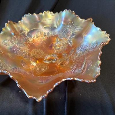 Sale Photo Thumbnail #820: Spring is in this bowl!

Fenton 3 Footed Bowl Marigold Carnival Glass Chrysanthemum & Windmill. 9 1/2" across x 4 1/2" high.

No chips, cracks or damage.

See pictures for details.