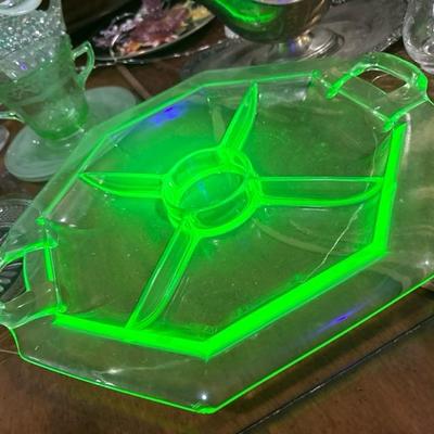 Sale Photo Thumbnail #824: This is a heavy uranium glass for compartment hors dâ€™oeuvre tray with a center area for a dipping sauce. It has one small nibble on the edge. Please see the photos otherwise great condition for an antique piece very heavy uranium. See photos for Ge