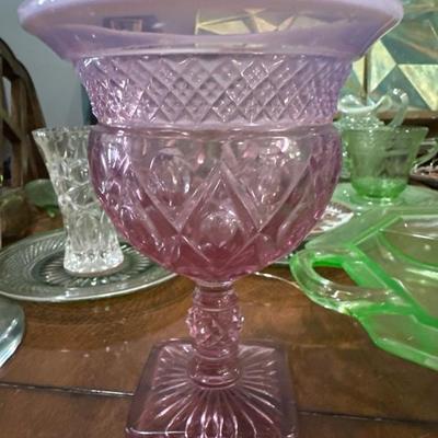 Sale Photo Thumbnail #840: Still seeking to identify the pattern on this late mid century vintage, Fenton rose glass compote this piece stands about 7 inches high and nearly 5 inches across it is very sturdy with a strong detailed rose colored base.