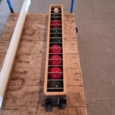 BOCCE BALL WITH A WOODEN STORAGE CASE ON WHEELS