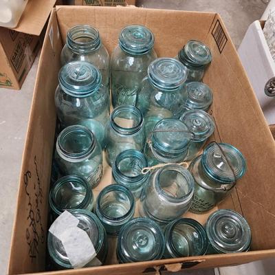Box of misc blue jars and lids.
