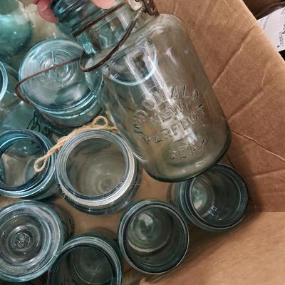 Box of misc blue jars and lids.