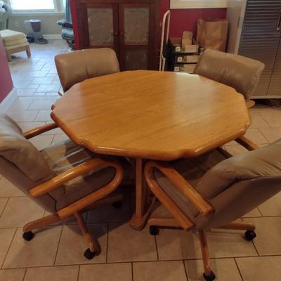 Solid Oak Octagonal Dining Table with Four Upholstered Rolling Chairs includes One Leaf Insert