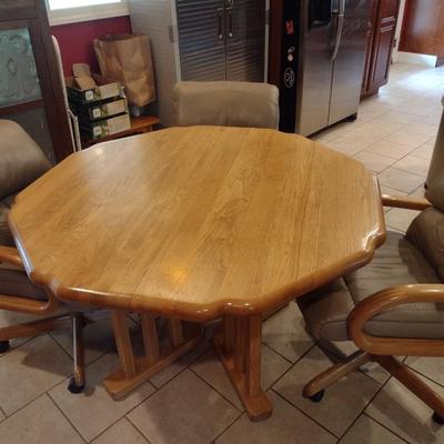 Solid Oak Octagonal Dining Table with Four Upholstered Rolling Chairs includes One Leaf Insert