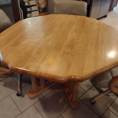 Solid Oak Octagonal Dining Table with Four Upholstered Rolling Chairs includes One Leaf Insert