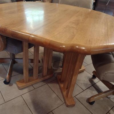 Solid Oak Octagonal Dining Table with Four Upholstered Rolling Chairs includes One Leaf Insert