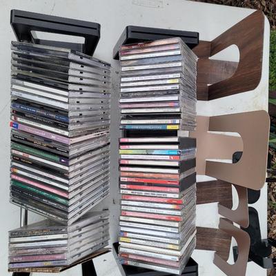 Lot of cds, cd holders, and bookends cd ends