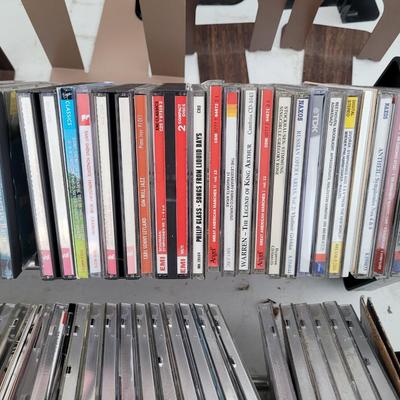 Lot of cds, cd holders, and bookends cd ends