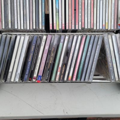 Lot of cds, cd holders, and bookends cd ends