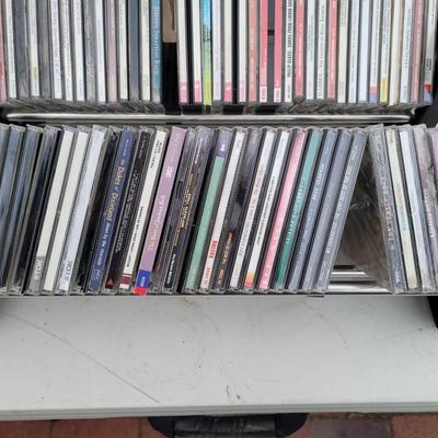 Lot of cds, cd holders, and bookends cd ends