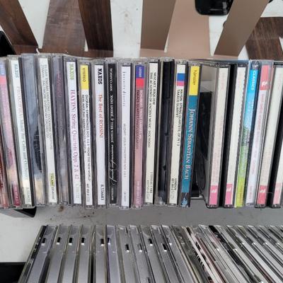 Lot of cds, cd holders, and bookends cd ends