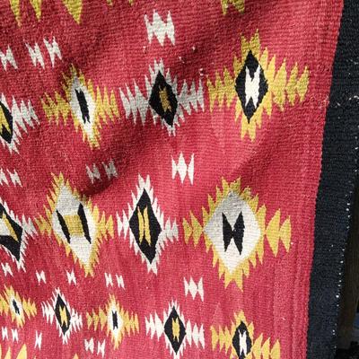 Colorful muti colored Native red rug appears handwoven.