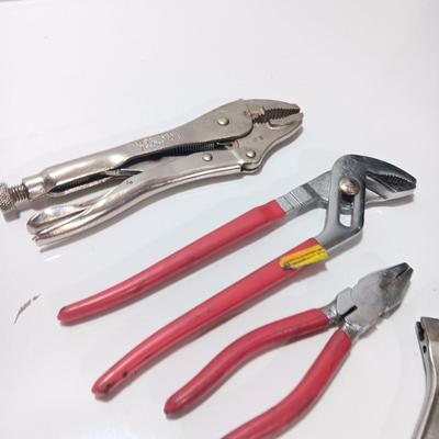 Variety of hand tools - Vise grips - pliers and an adjustable wrench